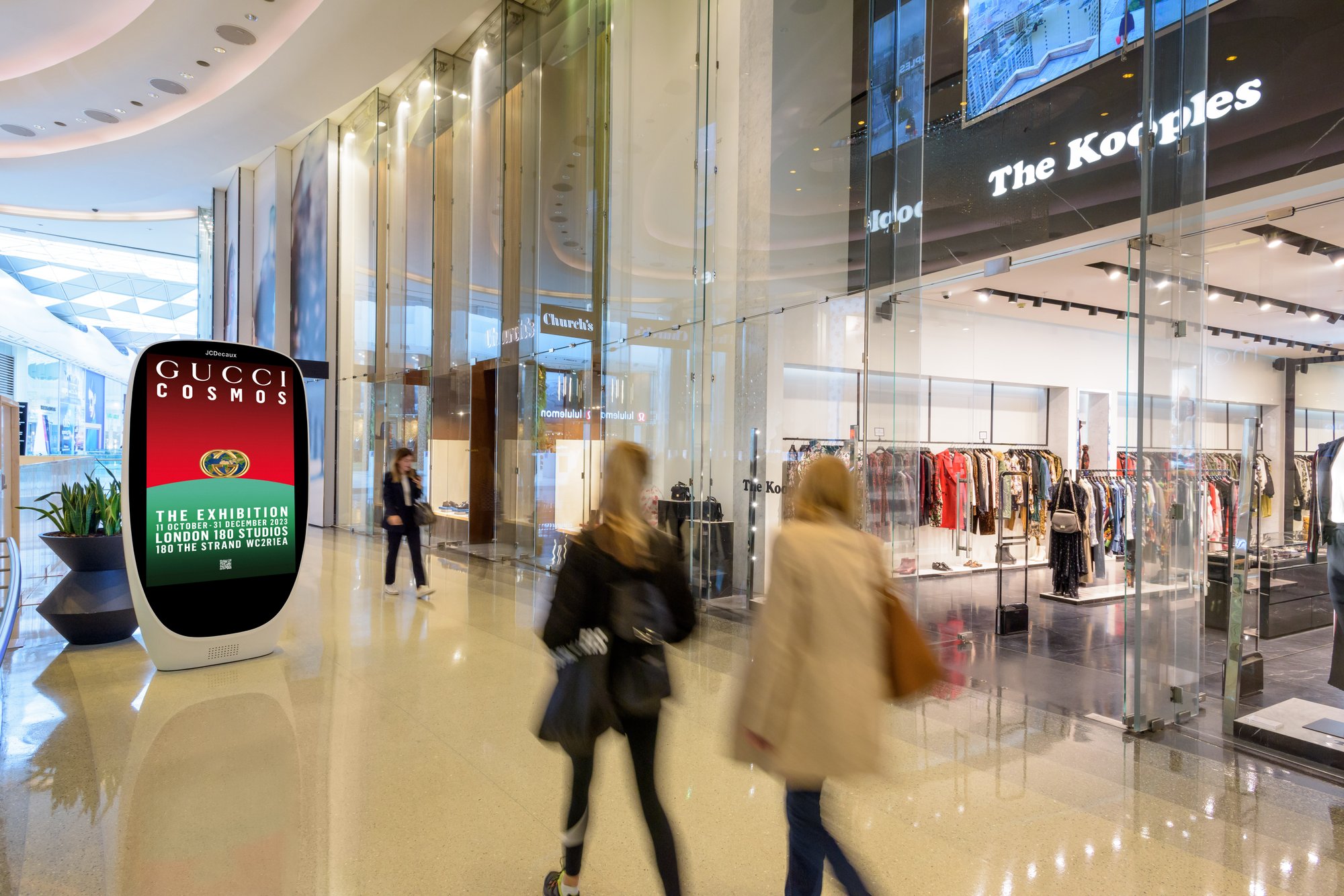 Digital screen in a shopping mall advertising Gucci Cosmos exhibition