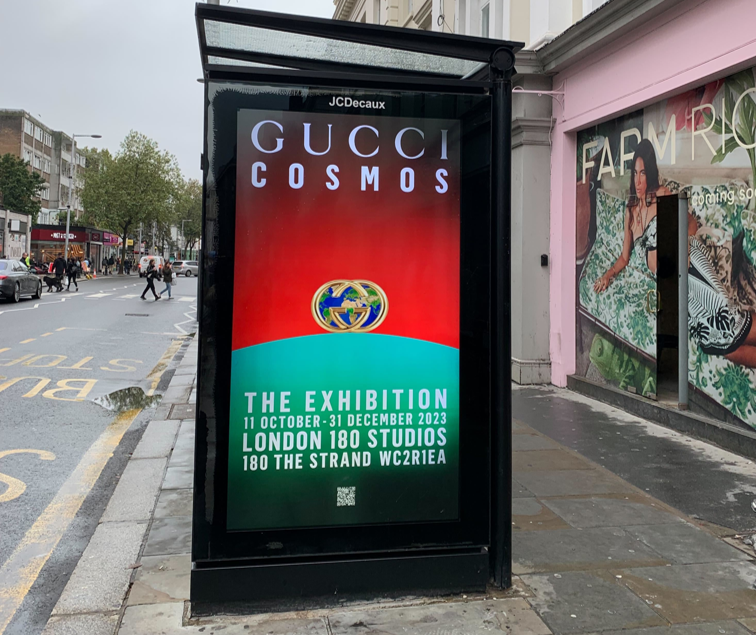 Bus shelter screen advertising Gucci Cosmos exhibition