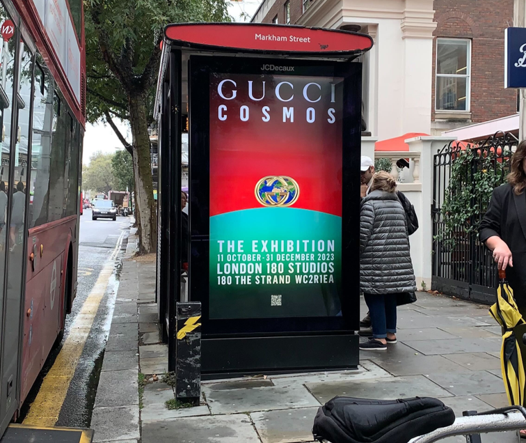 Bus shelter screen advertising Gucci Cosmos exhibition