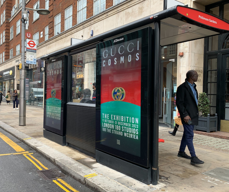 Bus shelter screen at Phillmore Gardens stop advertising Gucci Cosmos exhibition